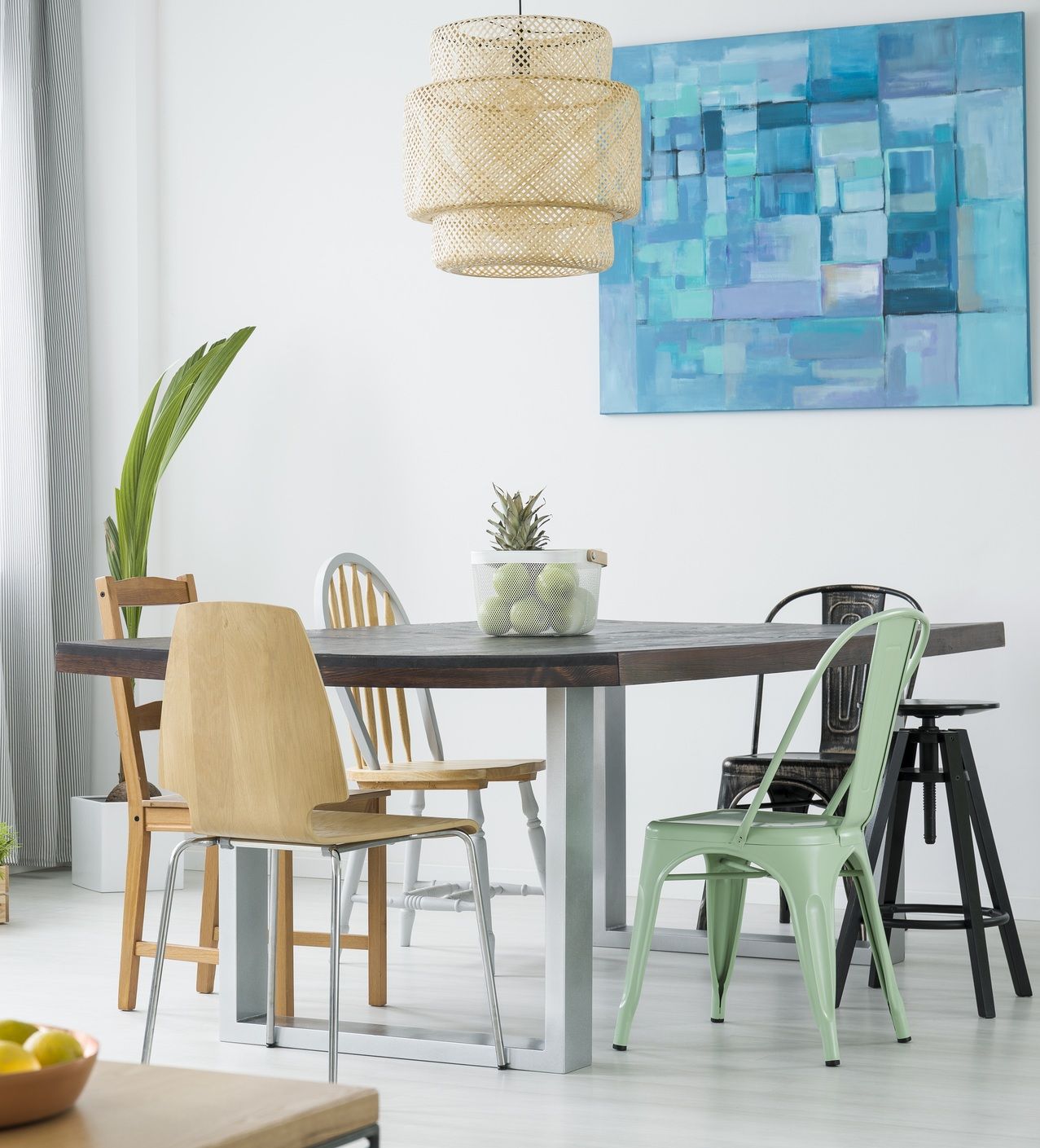 A dining space with light, natural touches like greenery and warm wood tones for spring